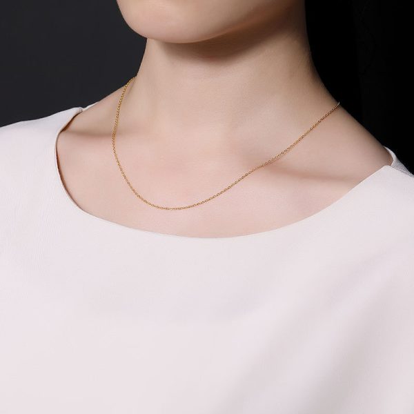 Elegant beauty in white wearing sterling silver gold-plated necklace