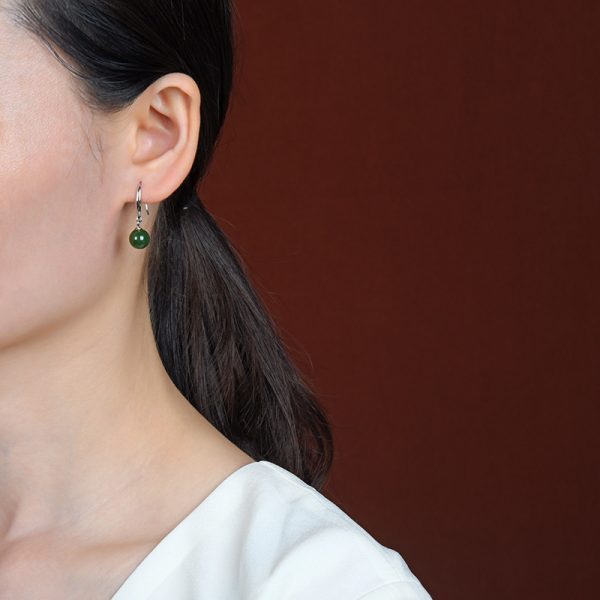 Girl wearing jasper bead earrings